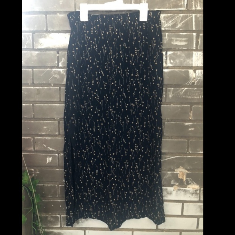 Black midi skirt with side slit.